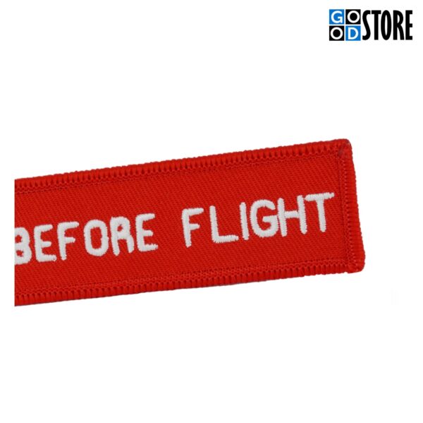 Noolekujuline punane "Remove Before Flight" võtmehoidja
